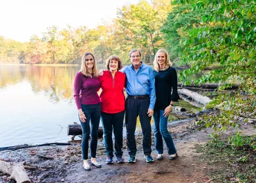 family standing by a lake